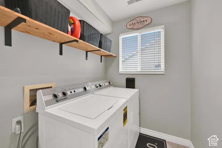 Laundry room with window and floating shelving