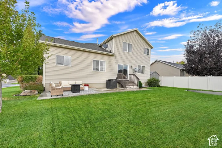 Expansive green lawn with large open patio