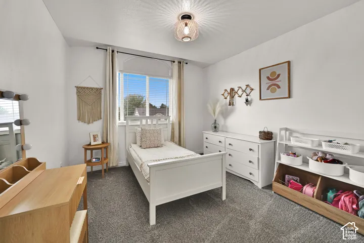 Spacious bedroom with drapes and adorable lighting