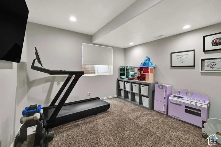 Bedroom with recessed lighting and roller shade