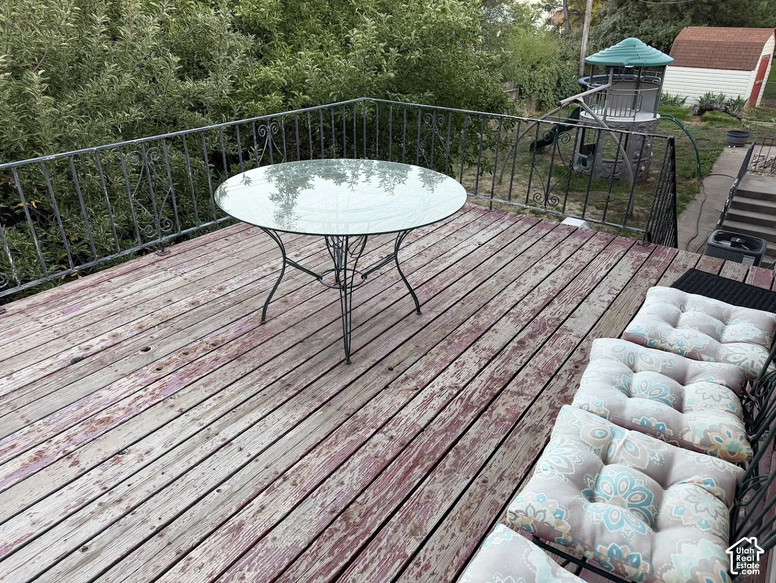 Outdoor deck featuring a wrought iron railing