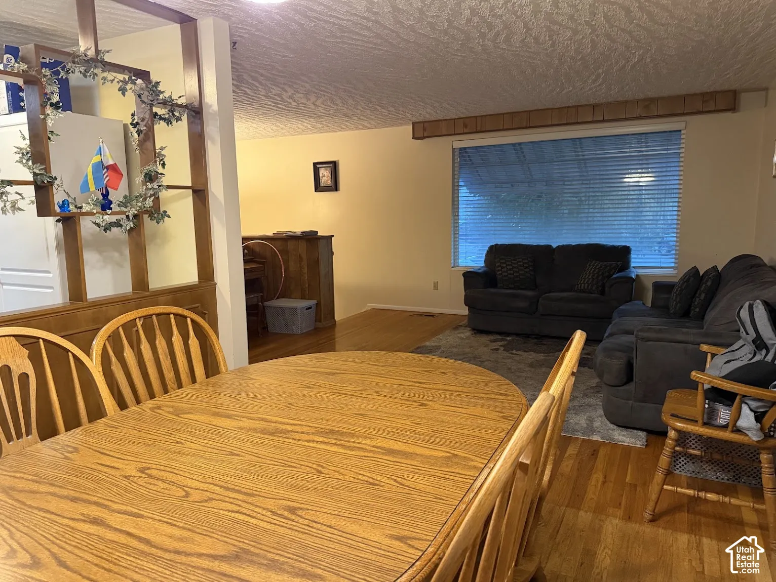Hardwood flooring throughout, with a large window providing natural light