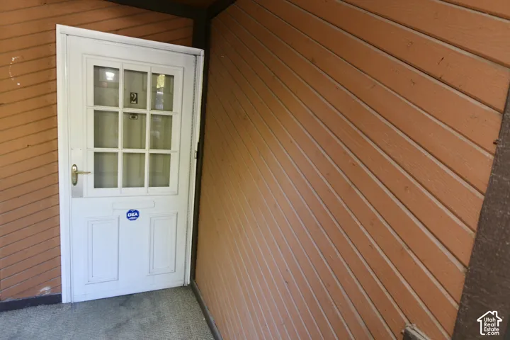 White panel door with glass inserts and a polished brass handle
