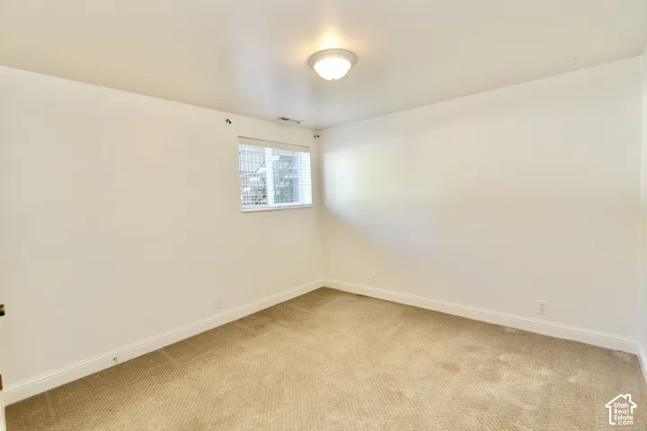Recessed window with horizontal blinds, carpeted flooring, and a flush mount ceiling light