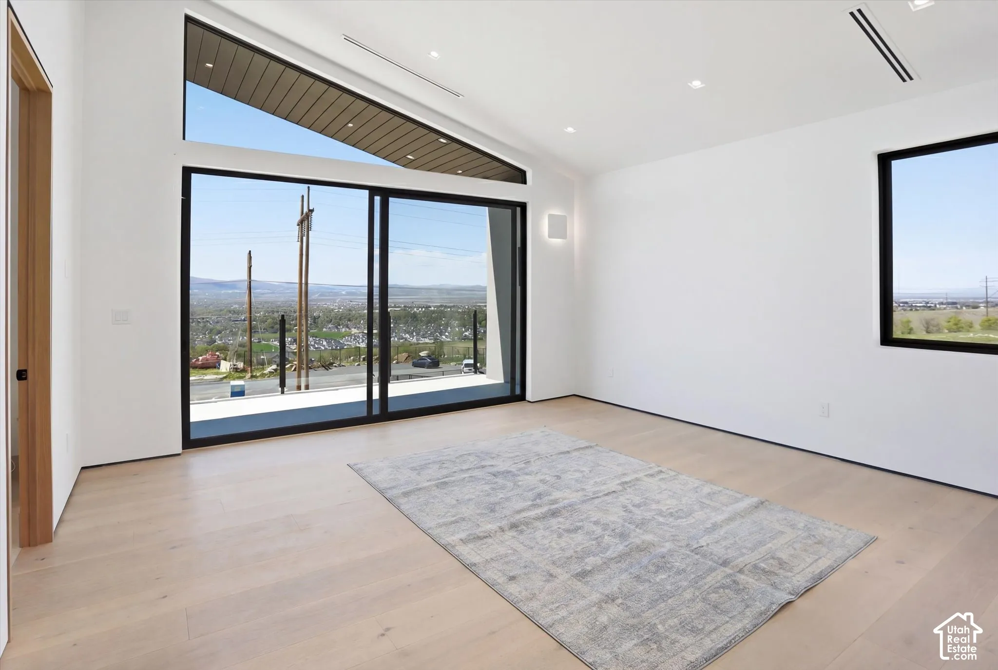 Secondary Bedroom 2: One of three main level bedrooms with east facing balcony access