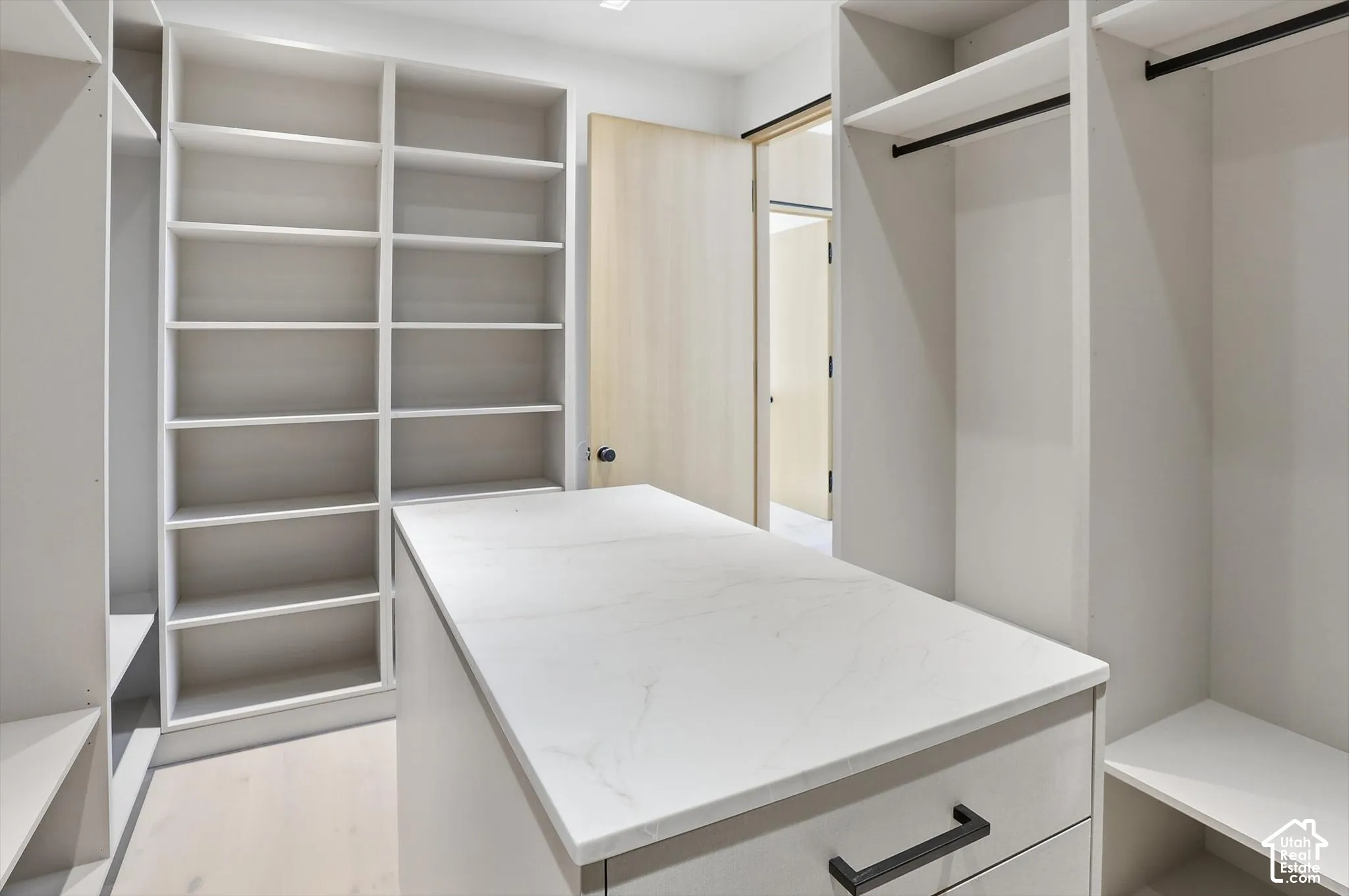 Center island in primary bedroom walk in closet
