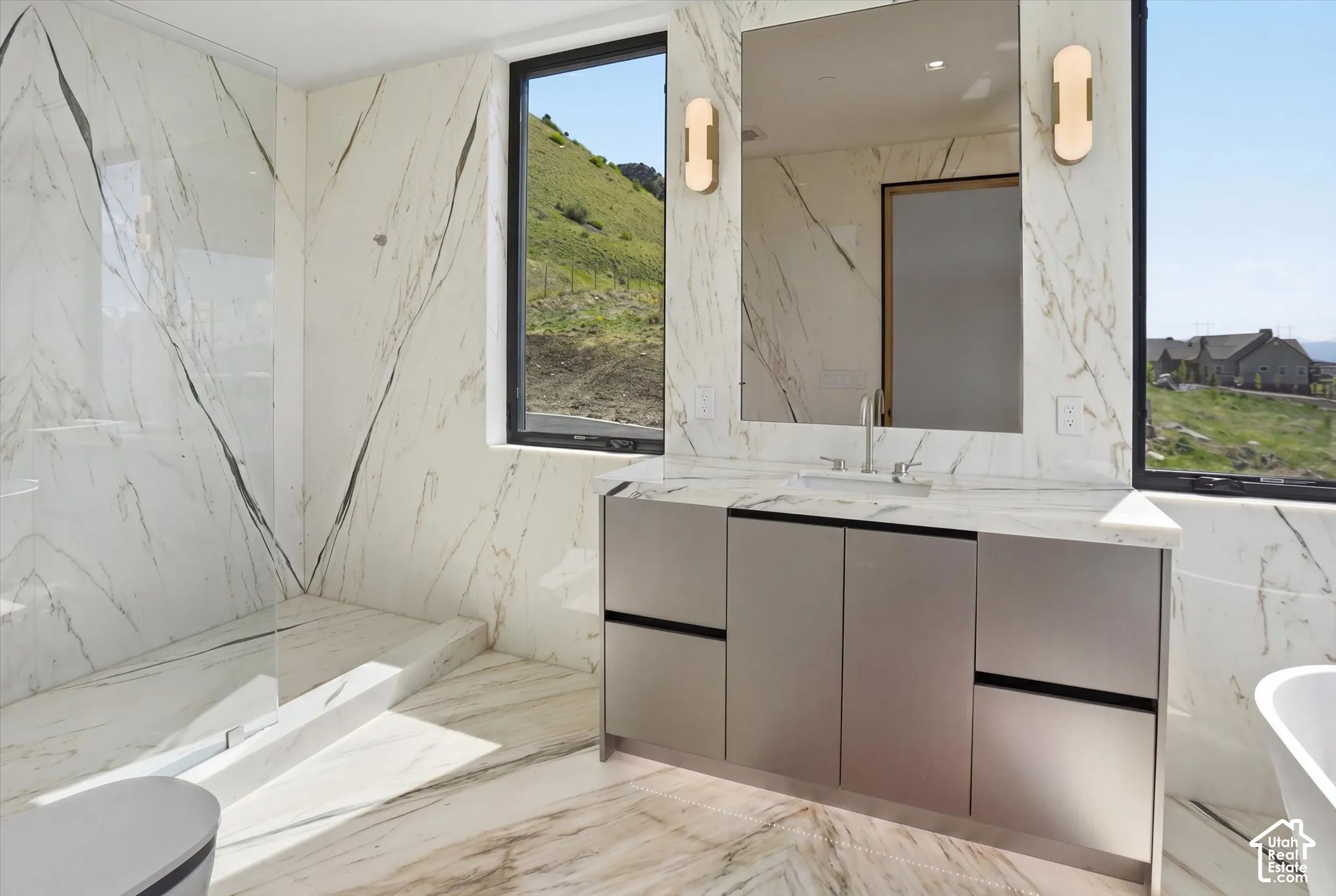 Shower and soaker tub in first primary suite bathroom