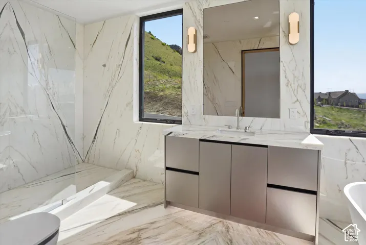 Shower and soaker tub in first primary suite bathroom
