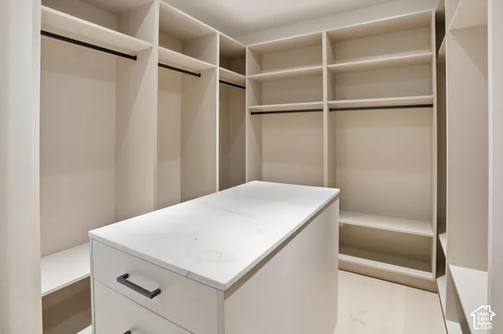 Ample room and organization in this primary suite walk in closet