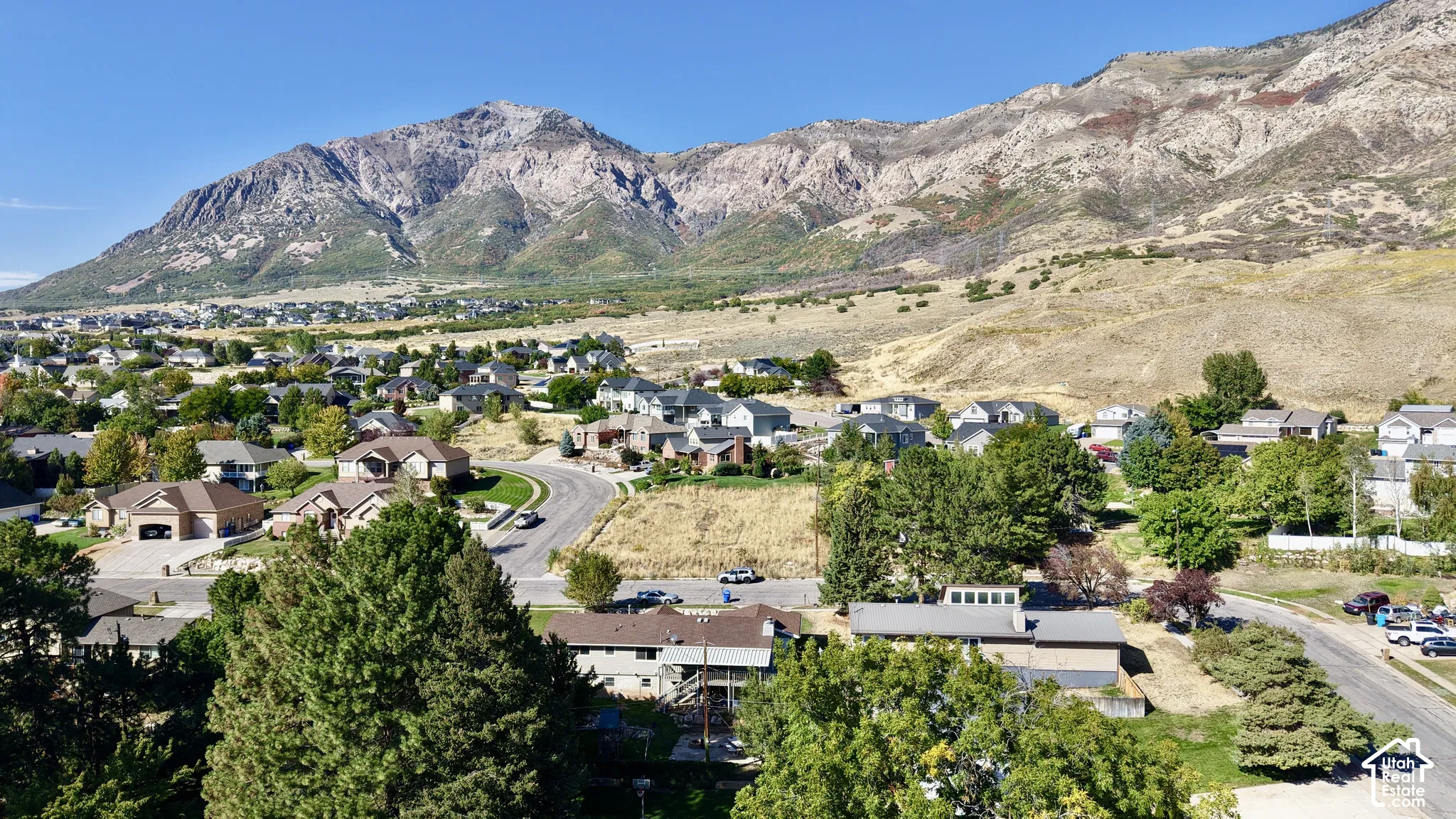 Expansive mountain range backdrop framing a residential area with varied housing styles
