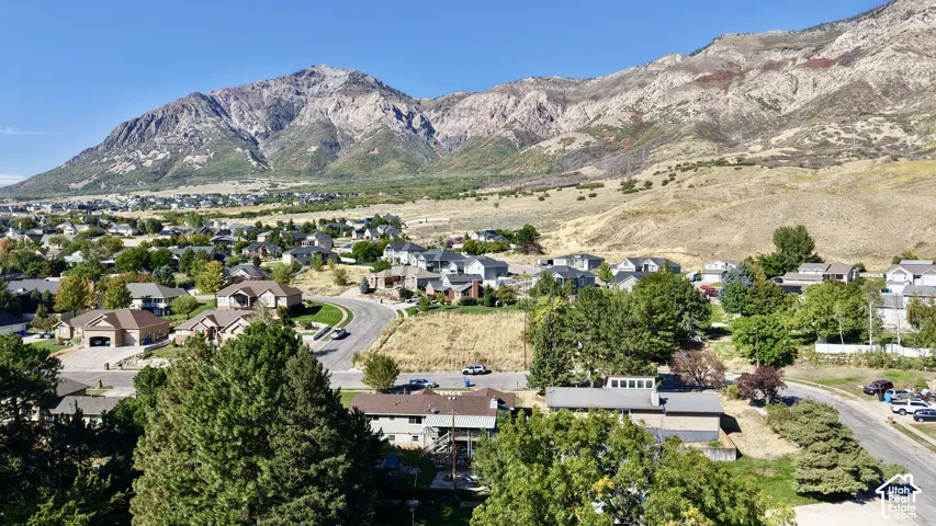 Expansive mountain range backdrop framing a residential area with varied housing styles