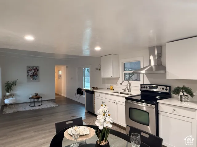 Contemporary kitchen with white cabinetry, stainless steel appliances, and white countertops
