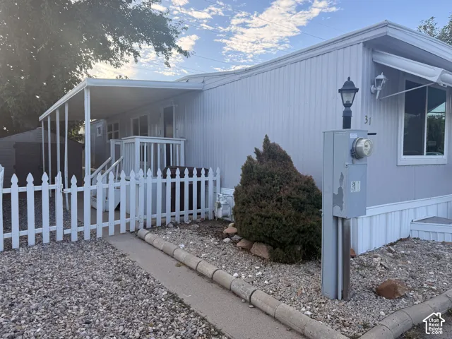 Covered entryway with white picket fence