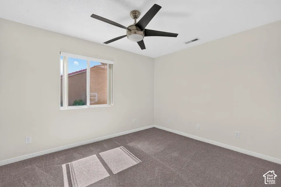 Neutral wall finishes, recessed window, and a ceiling fan with integrated lighting