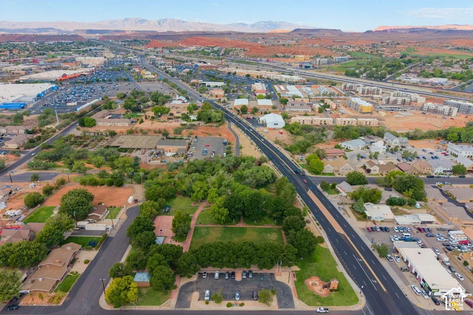 Expansive aerial perspective showcasing urban development, established roadways, and abundant mature trees
