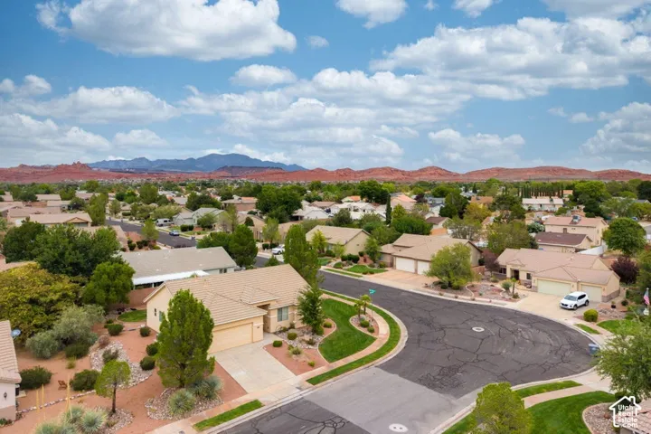 Residential neighborhood featuring single-story homes, mature landscaping, and a curvilinear street layout