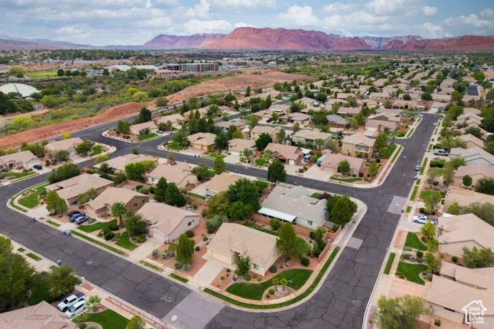 Neighborhood setting featuring paved streets, developed landscaping, and distant mountain scenery
