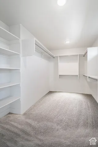 Primary bedroom walk-in closet digitally altered with carpet