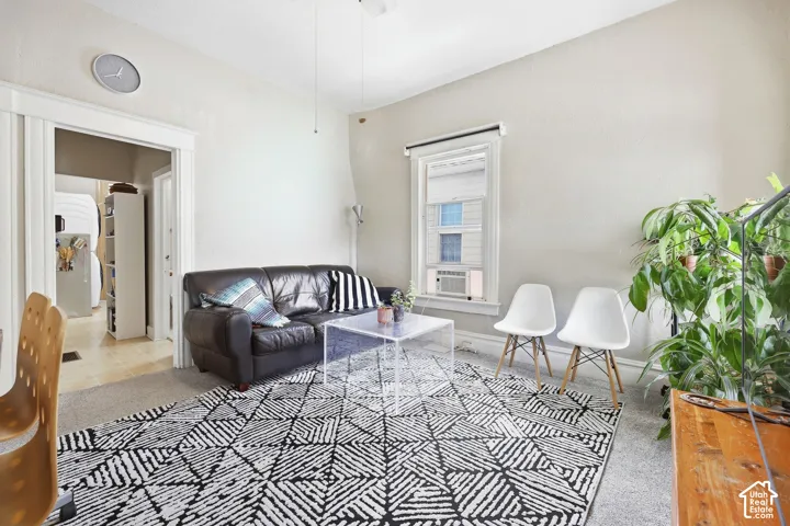 Light-toned walls with contrasting white trim, featuring an entryway opening and a single window