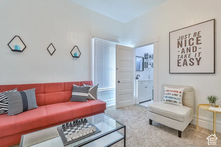 Plastered walls, built-in wall shelves, and an open doorway leading to a vanity