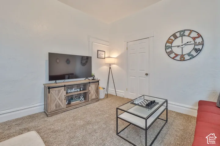 Textured walls, carpeted flooring, and white trim