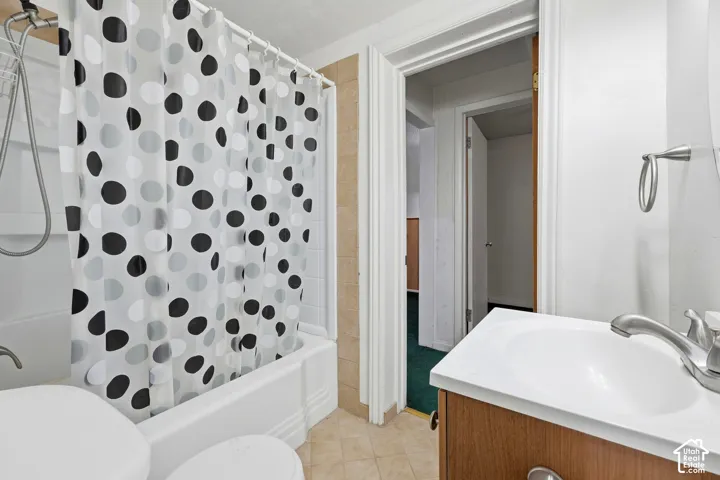 White vanity with integrated sink, chrome faucet, and wood-finish cabinetry