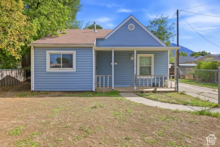 Blue siding exterior with a covered porch and white columns
