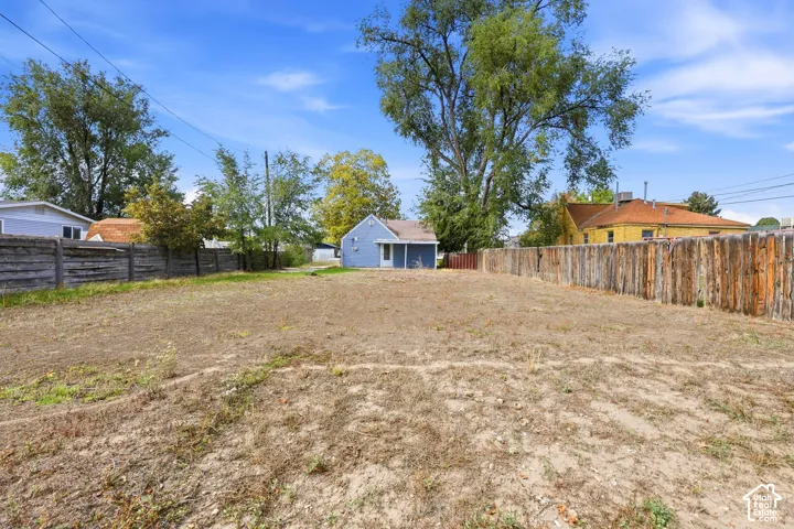 Expansive lot featuring mature trees and a perimeter privacy fence