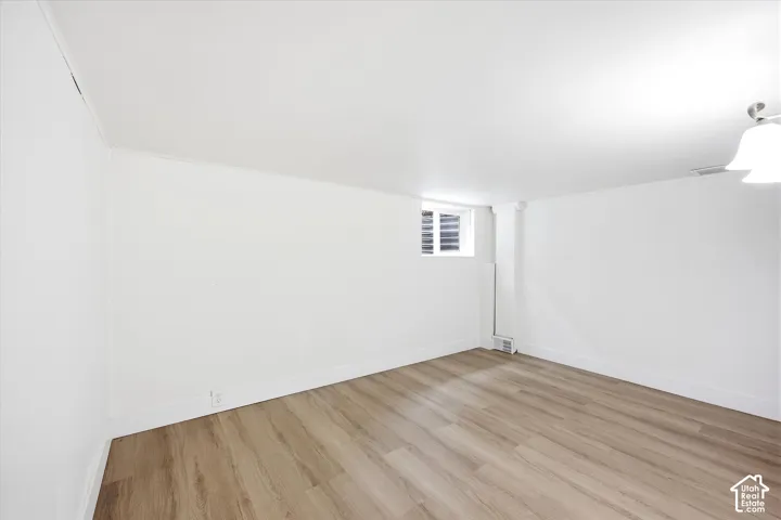 Wood-finish flooring with white walls and trim