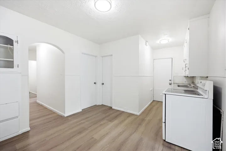 Wood-finish flooring throughout, with white painted walls and trim