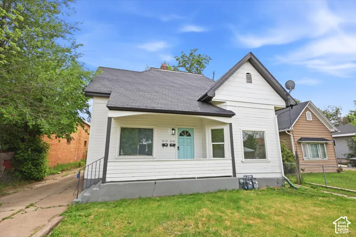 White exterior siding with a covered porch entry