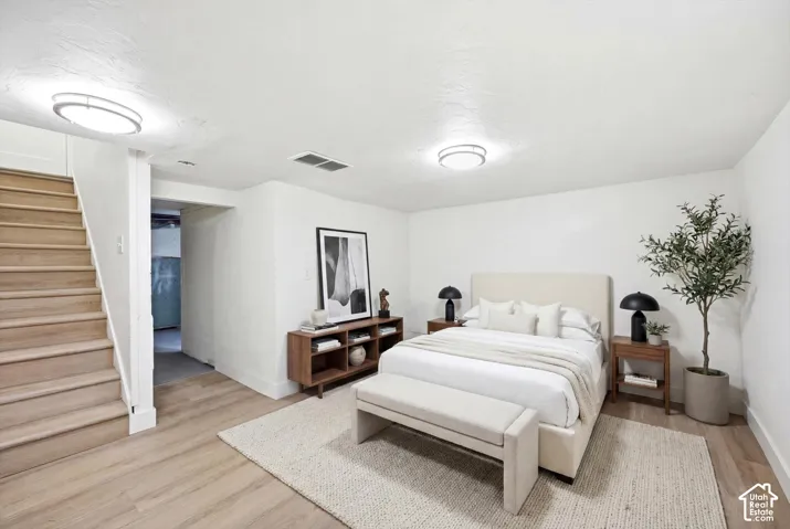 Wood-finish flooring throughout, complemented by a light-toned area rug