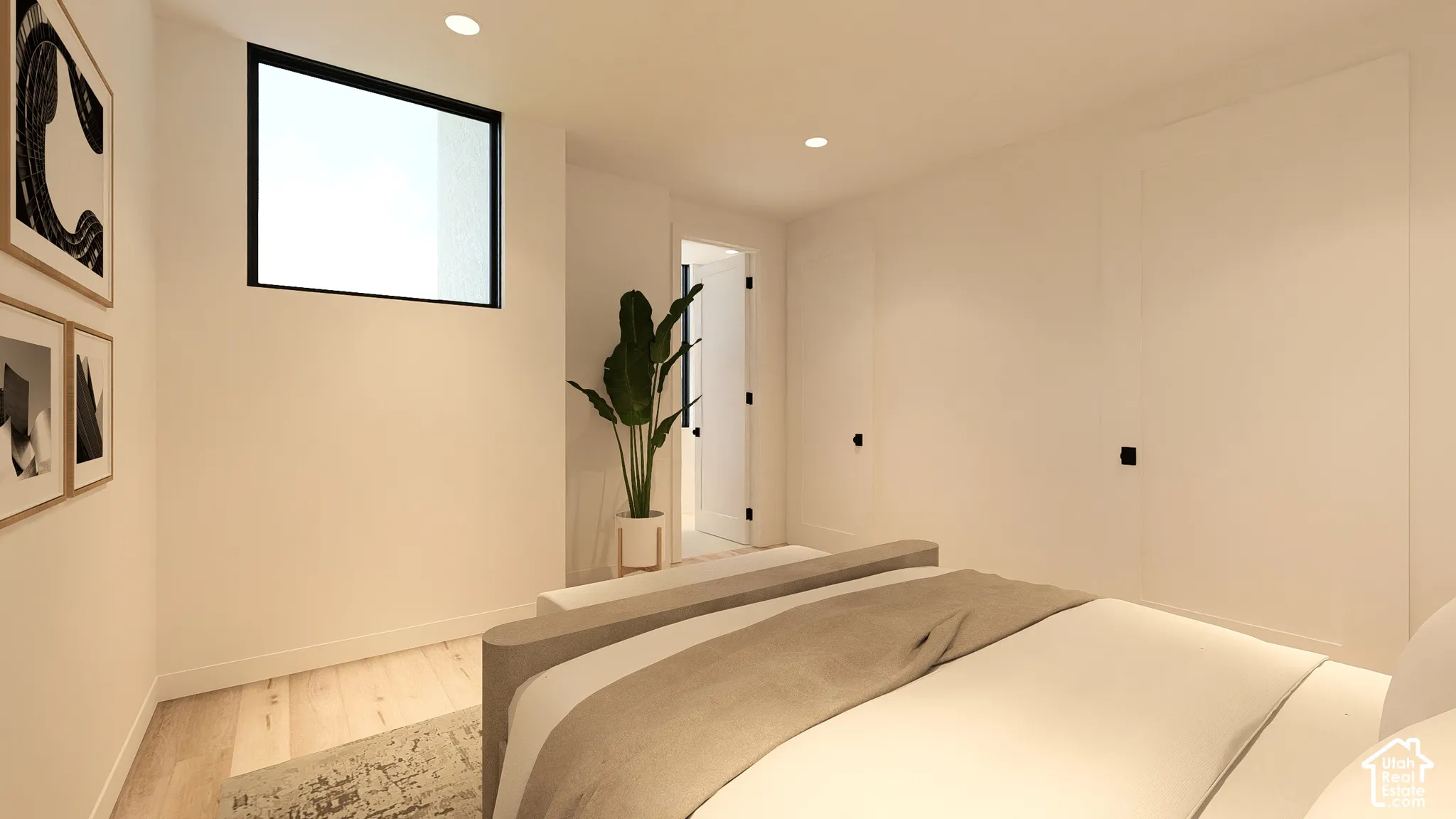 Recessed lighting illuminates the room, featuring light wood-finish flooring and a black-framed transom window