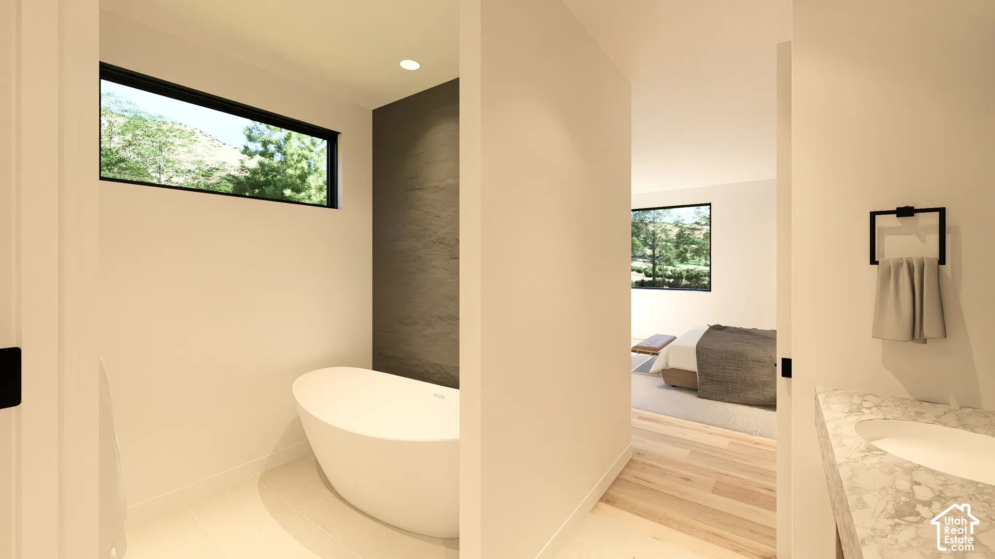Freestanding soaking tub with a rectangular window, recessed lighting, and a textured accent wall