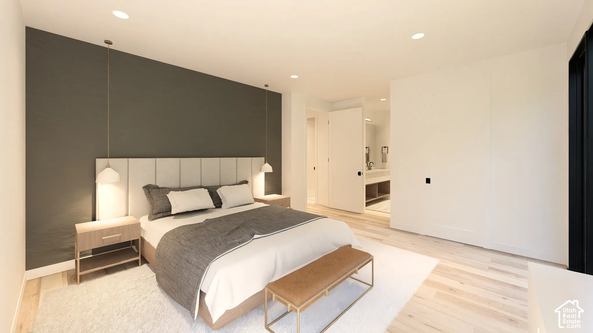 Recessed lighting illuminates the space with light wood-finish flooring