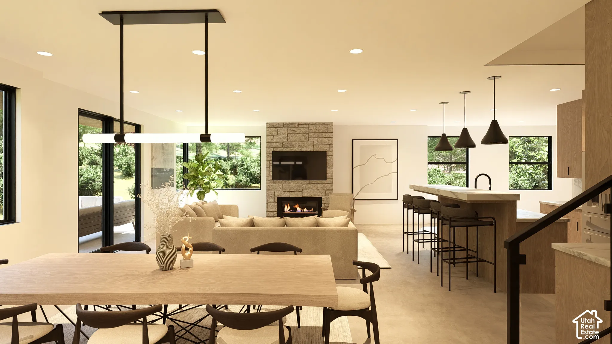 Open-concept interior featuring recessed lighting, a floor-to-ceiling stone-clad fireplace, and a kitchen island with pendant lighting