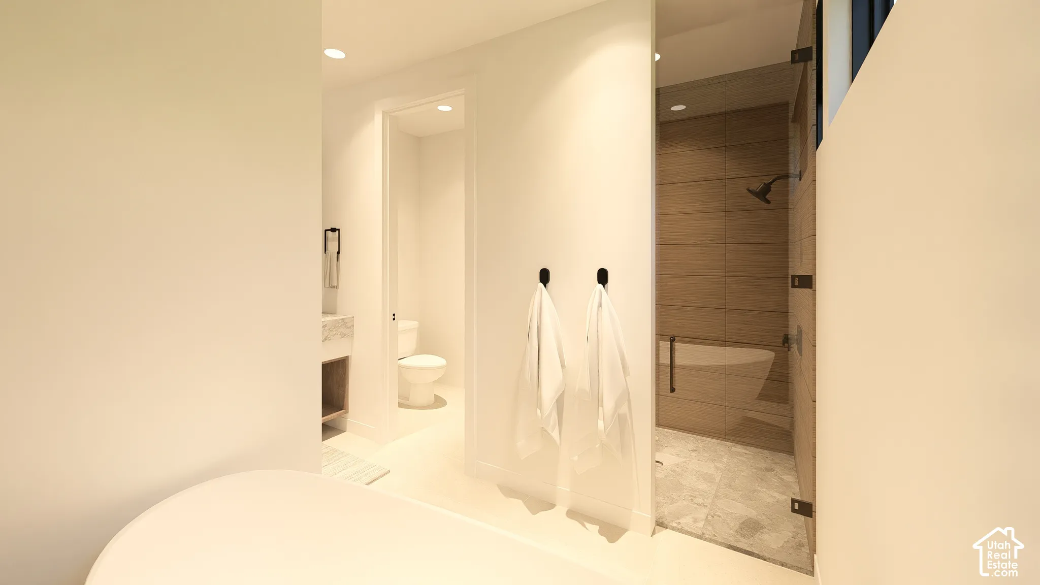 Freestanding soaking tub, glass-enclosed shower with a built-in bench, wall-mounted showerhead, and tile surround