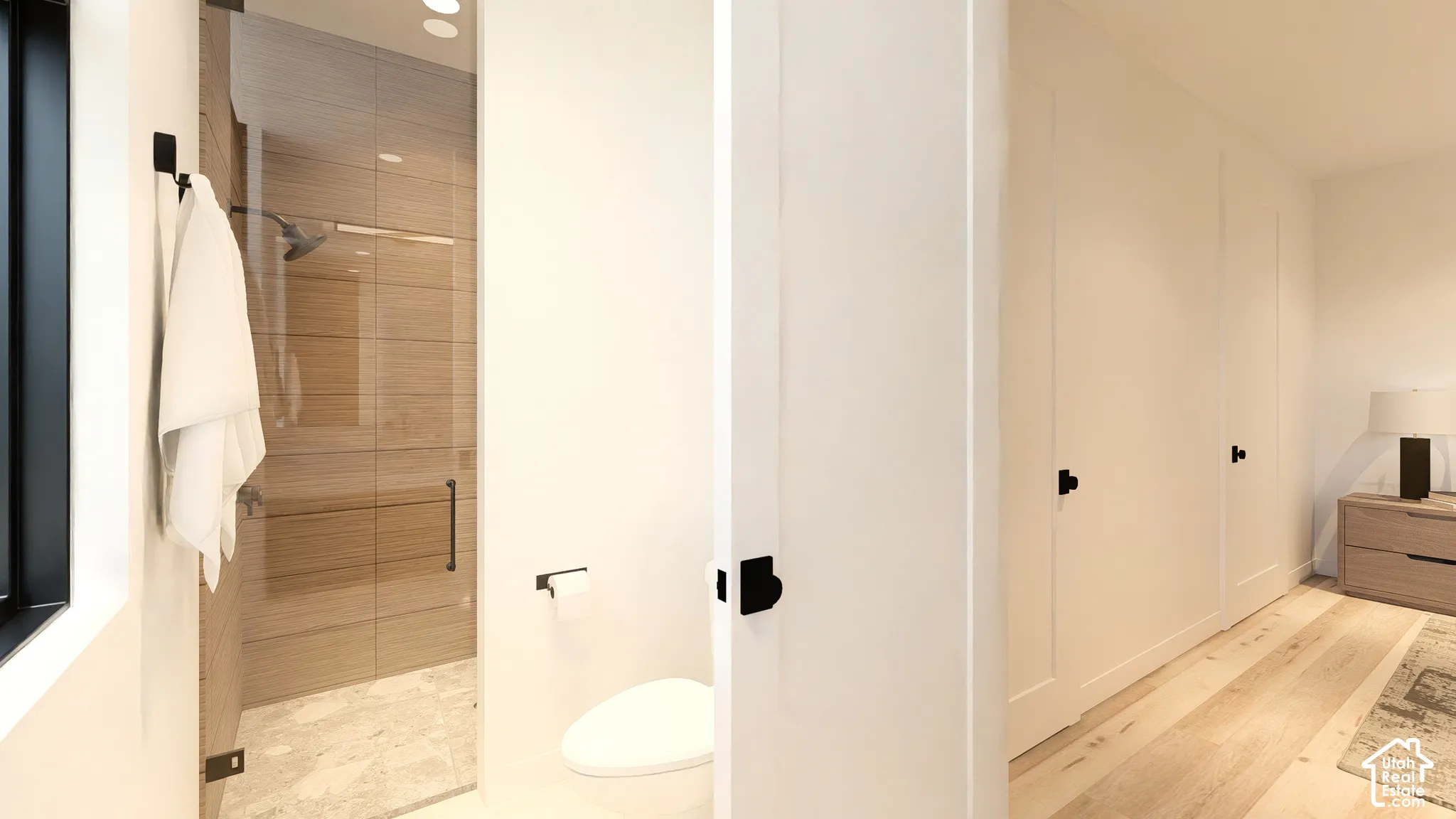 Glass-enclosed shower with wood-finish tile and recessed lighting