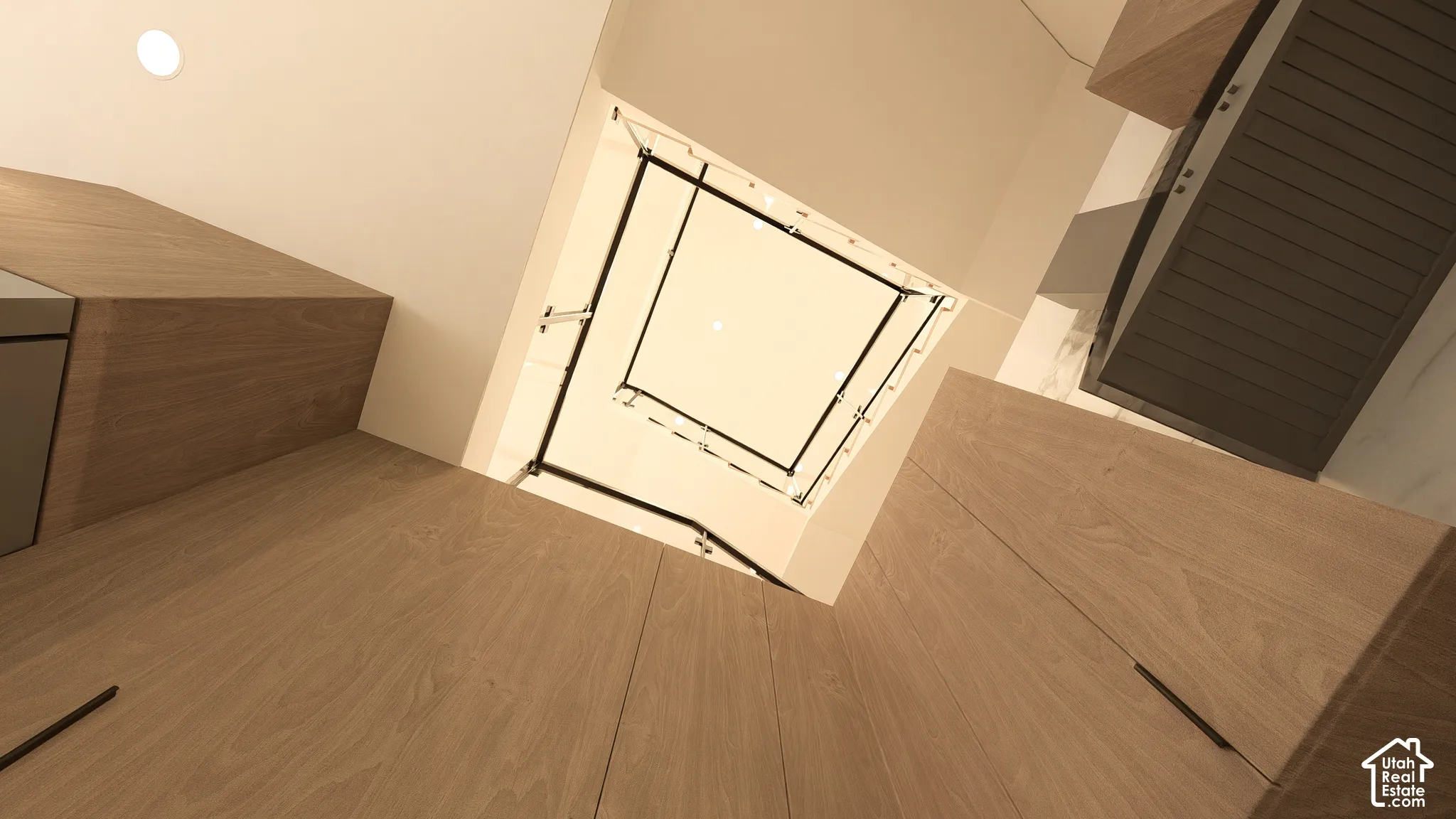 Hardwood flooring, recessed ceiling lighting, light wood-finish cabinetry, and a dark louvered cabinet