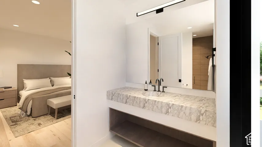Floating vanity with a stone countertop, integrated sink, and black matte faucet