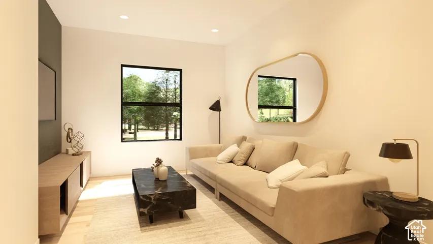 Recessed lighting, wood-finish flooring, a wall-mounted media console, and a large window featuring outdoor scenery