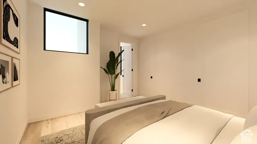 Recessed lighting illuminates the room, featuring light wood-finish flooring and a black-framed transom window