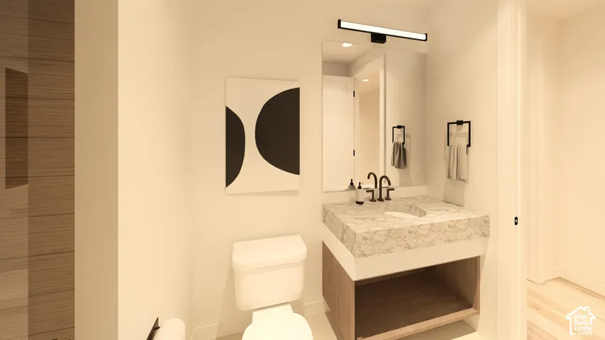 Floating vanity with integrated basin, matte black wall-mounted faucet, and illuminated mirror