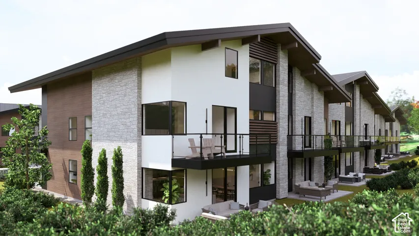 Contemporary townhome architecture featuring multiple balconies, expansive windows, stone veneer accents, and a low-slope roofline