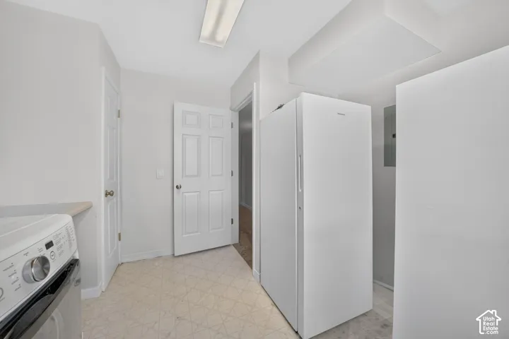 White painted doors, overhead fluorescent lighting, and a neutral-toned floor