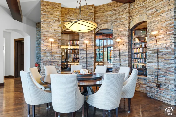Main Dining with exquisite conditioned wine room or library backdrop. Sellers have retained shelving to accommodate wine or books.