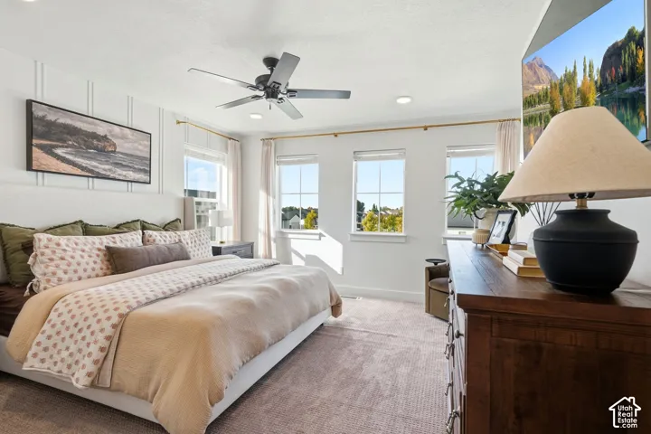 White shiplap accent wall, recessed lighting, and a ceiling fan with integrated lighting
