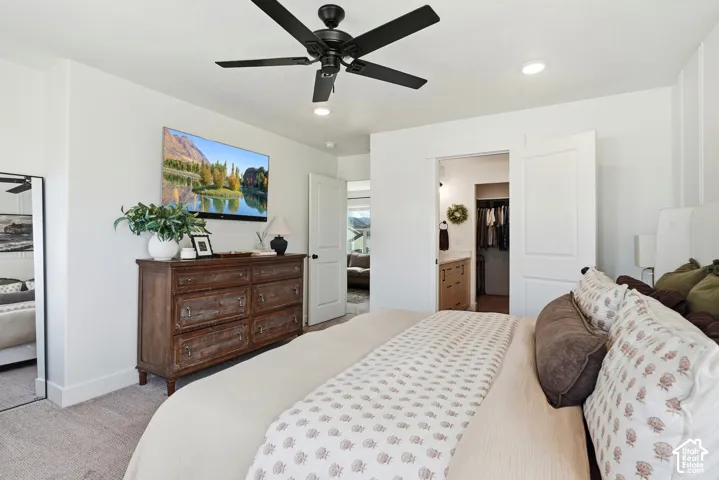Recessed lighting, ceiling fan with black finish, light-colored carpeting, white wall finishes, and white interior doors