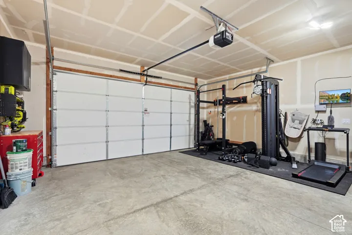 Attached two-car garage featuring a concrete floor and an automatic garage door opener