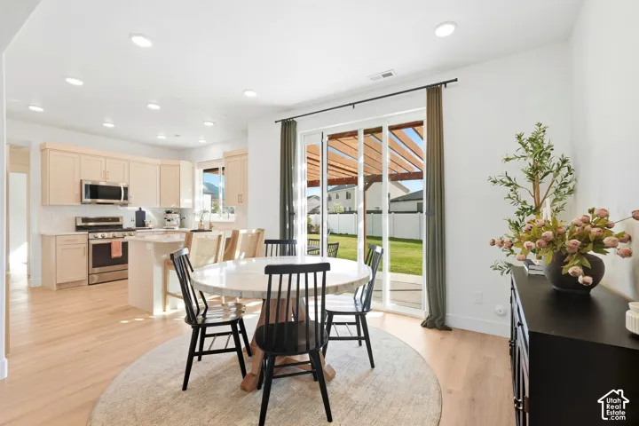 Gourmet kitchen with light-toned cabinetry, stainless steel appliances, and a central island